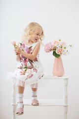 beautiful little blonde girls with  flowers on white background