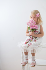 beautiful little blonde girls with pink flowers on white background