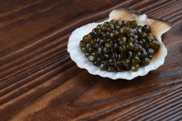 Black sturgeon caviar in sea shell. macro
