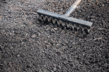 background rake cultivating black earth