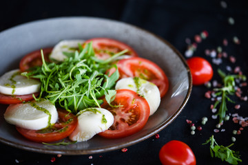 italian caprese salad with fresh mozzarella, tomatoes & basil