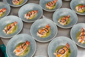 Many plates of shrimp on the kitchen table