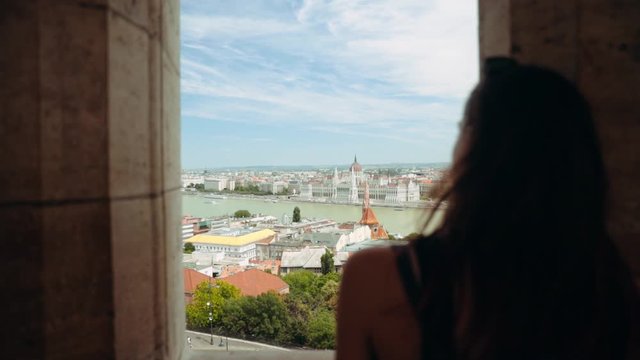 Shot back view young woman stand old arches on city street attractive casual cell fashion smartphone happy portrait cute eyes girl looking model pretty sensuality close up slow motion