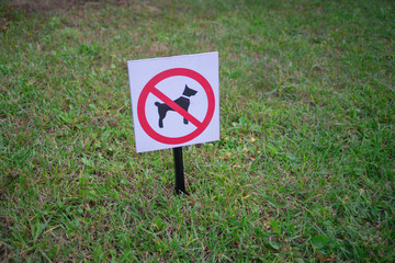 bright sign dogs forbidden on a green lawn