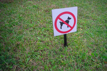 bright sign dogs forbidden on a green lawn
