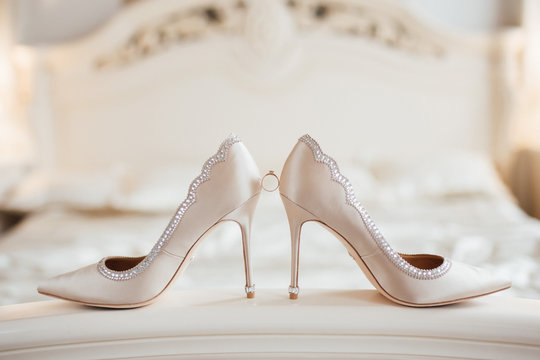 The wedding rings on the bride's shoes