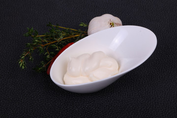 Fototapeta na wymiar Mayonnaise sauce in the white bowl served thyme and garlic