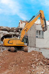 Excavator storms old house