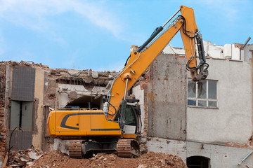 Excavator storms old house