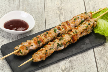 Minced pork skewer kebab with sauce