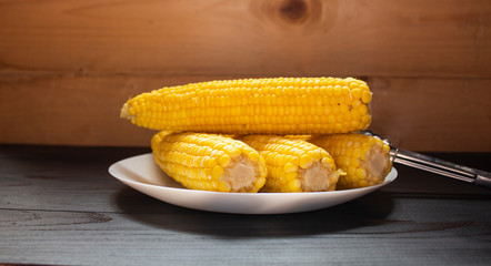 Grains of ripe corn. An ear of corn isolated. Corn on the cob, meal ripe juicy tasty corn. Photo of corn background.Fresh young sweet corn on cobs, closeup.