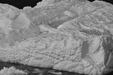 Closeup of Iceberg with Inner Pool and Pock Marks in Antarctica in Black and White