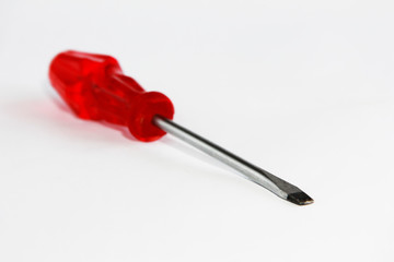 old rusty metal screwdriver for screws with red handle
