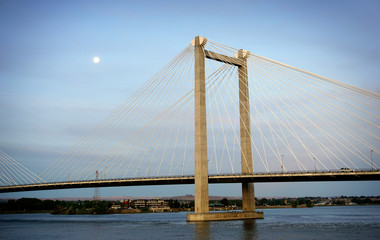 Cable susoension bridge over Columbia river at dawn with moon in sky