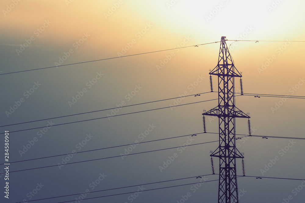 Wall mural overhead electrical power lines on a transmission tower against clear sky background. electric energ