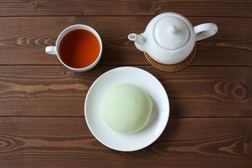 お皿にのせた メロン パン 紅茶 木のテーブル