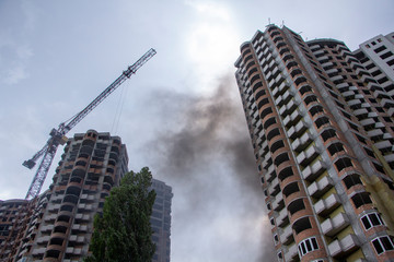 Fototapeta premium Fire At a construction site, unfinished multi-storey reinforced concrete building