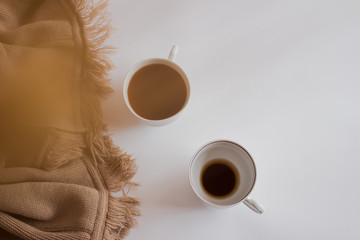 Cup of coffee on pastel plaid background. Flat lay, top view
