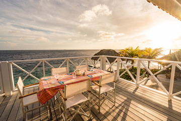 Sunset over the sea from a house and swimming pool