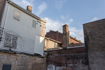 Fototapeta na wymiar Looking up at vintage brick buildings in alley