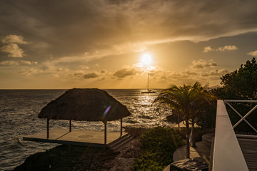 Sunset over the sea from a house and swimming pool