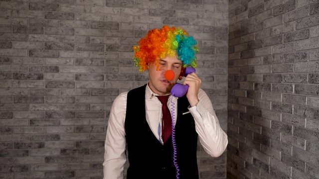 Young clown businessman working in the office