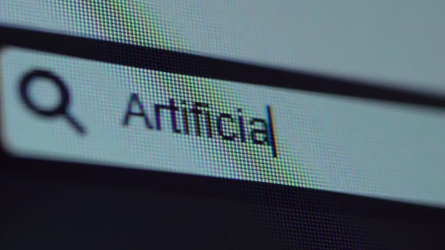 Browser bar with typed Artificial Intelligence text on the computer monitor. Shot in 4k resolution
