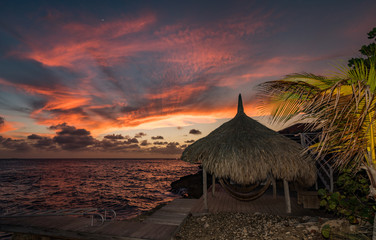 Sunset over the sea from a house and swimming pool