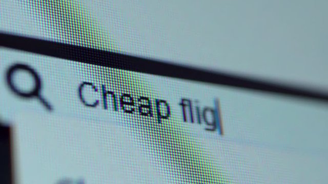 Browser bar with typed Cheap Flight Tickets text on the computer monitor. Search Engine Concept. Shot in 4k resolution