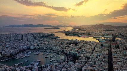 Obraz premium Aerial drone photo of iconic round port of and Marina of Zea or Pasa Limani at sunset with beautiful golden colours and cloudy clear sky, Piraeus, Attica, Greece