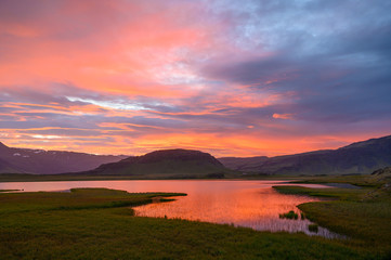 Amazing icelandic sunrise with reflection in the pond