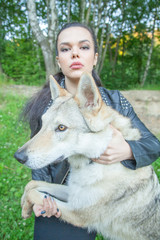 Adult pretty model girl with real mix animal of wolf and dog