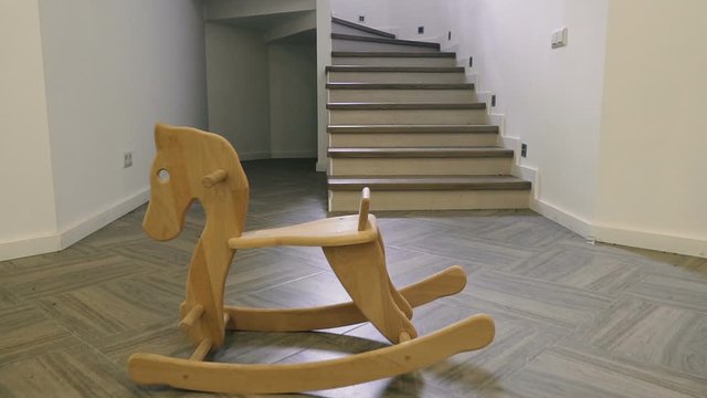 Children's wooden horse stands in the middle of the house