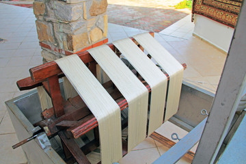 Spinning wheel for separating fine silk threads from cocoons in a kibbutz in Turkey near Selcuk.