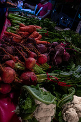 Radishes, carrots & celery. vibrant reds and greens, laid out at the farmers market for patrong.