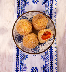 Austrian and czech sweet dessert knedle apricot dumplings on fabric with ornament background. Filled cottage cheese dough. close up