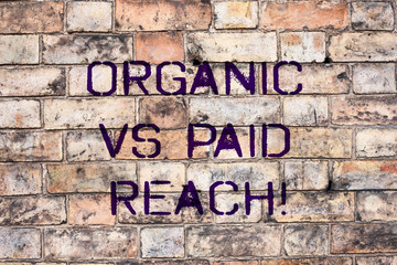 Handwriting text Organic Vs Paid Reach. Concept meaning Increasing followers naturally or by paying...
