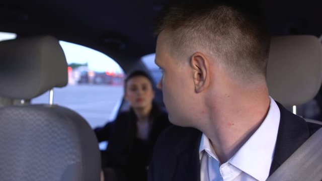 Taxi driver waiting for passenger near shopping mall, lady sitting into car