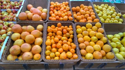 Problems of spoiled products in a supermarket.  Citrus fruits on the shelves in the store: grapefruit, orange, tangerines, lemons.  Expired Food. The concept of quality and customer care. Organic food