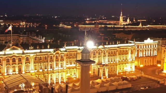 Aerial around view of the Alexander Column on Palace Square, the Winter Palace and the General Staff Building in St. Petersburg at night, Russia