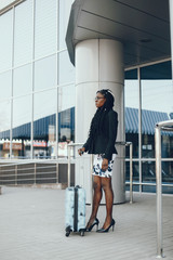 Obraz premium Cute black woman a city. Beautiful black girl in black jacket