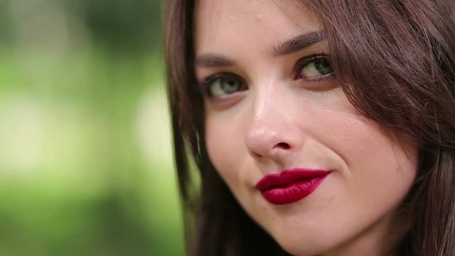 Pretty woman seductively eating cherry