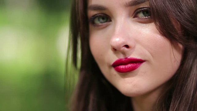 Pretty woman seductively eating cherry