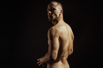 Fototapeta premium Handsome sport sexy stripped guy portrait for cosmetics and fitness drops on isolated black background