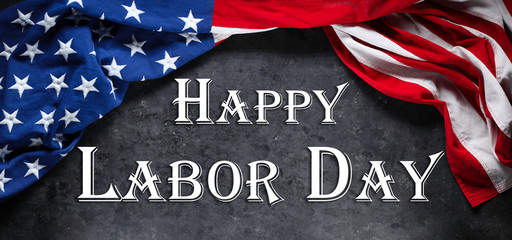 Fototapeta na wymiar US American flag on worn black background. For USA Labor day celebration. With Happy Labor Day text.