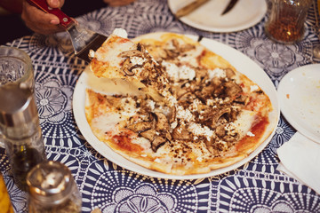People eating gourmet mushroom funghi pizza