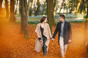Fototapeta premium lovely couple walking around the park during autumn
