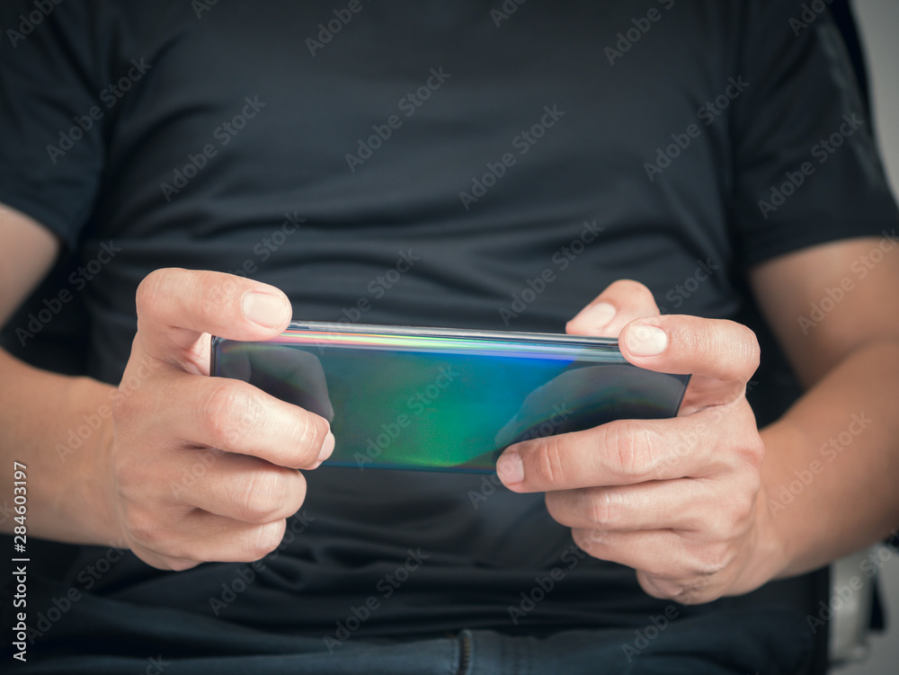 Poster Man playing game on smartphone.