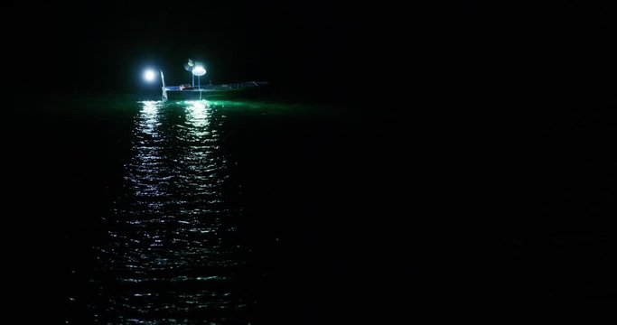 Fishing vessel with lights at night sea near Sibenik in Croatia