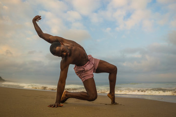 contemporary dance choreographer and dancer doing ballet beach workout . a young attractive and athletic black African American man dancing in dramatic performance